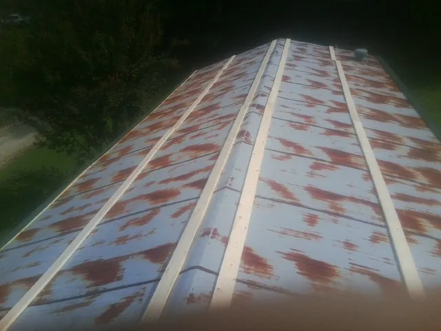 Rusted metal roof panels with new wood purlins before replacement — Storm Damage Roof Repair in Capistrano Beach by Roofing Brothers