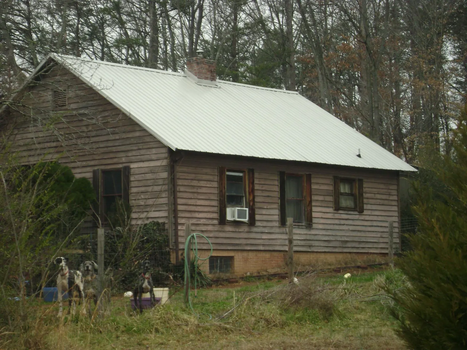 White metal roof on an old wood sided farmhouse, from a Metal Roof Installation job in Capistrano Beach